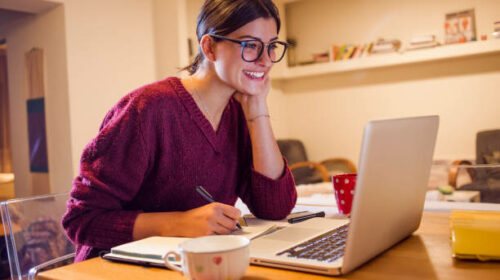 beautiful smiling woman using her computer