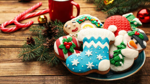 Delicious homemade Christmas cookies and festive decor on wooden table